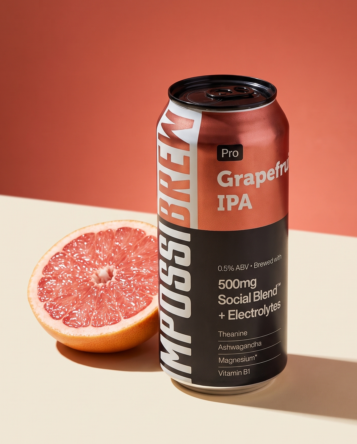 IMPOSSIBREW Pro Grapefruit IPA can with fresh pink grapefruit on copper-red studio background